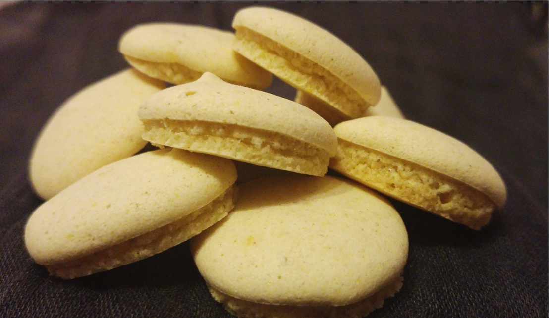 A pile of white, round, small anise cookies