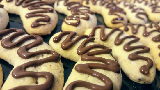 Almond crescent cookies decorated with melted chocolate
